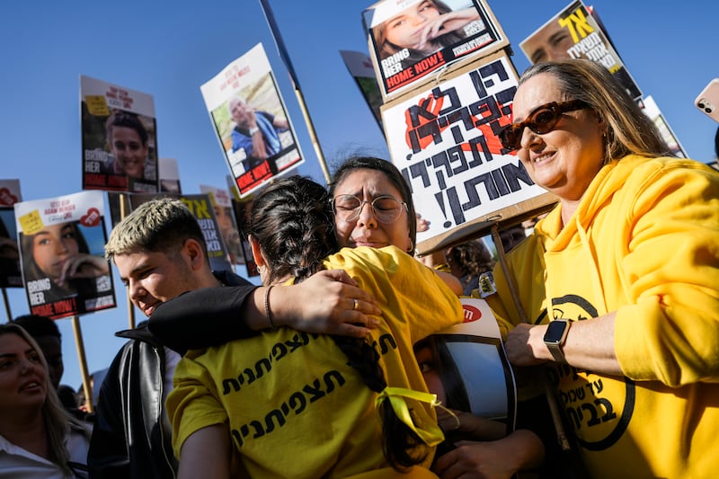 Israelis react as they watch a broadcast of the release of Israeli soldier Agam Berger in Tel Aviv, Israel (Oded Balilty/AP)