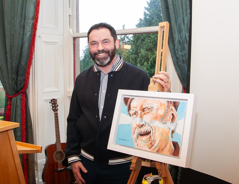 Artist Micheal Gallagher presents his portrait of the poet to The Pádraic Fiacc Archive