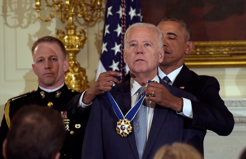 Then-president Barack Obama presents then-vice president Joe Biden with the Presidential Medal of Freedom during a ceremony in 2017 (Susan Walsh/AP)