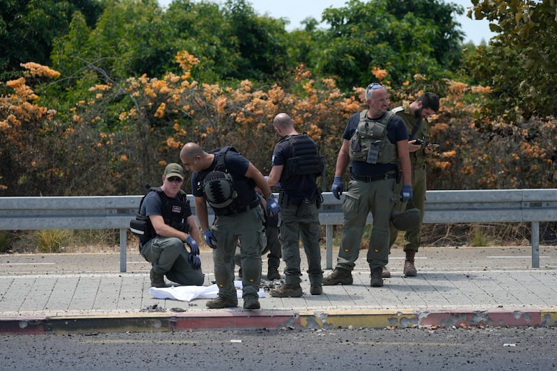 Israeli police work at the site of a drone strike in Nahariya, Israel (Ohad Zwigenberg/AP)