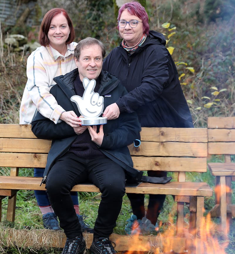 Actor and comedian Ardal O'Hanlon presents sisters Kathleen Finnegan-Agnew and Margaret Finnegan with a National Lottery Award at their social farm and community wellness centre in South Armagh