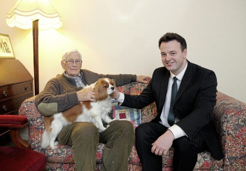 Mallon with current SDLP leader Colum Eastwood and his dog Jessie Picture: Cliff Donaldson 