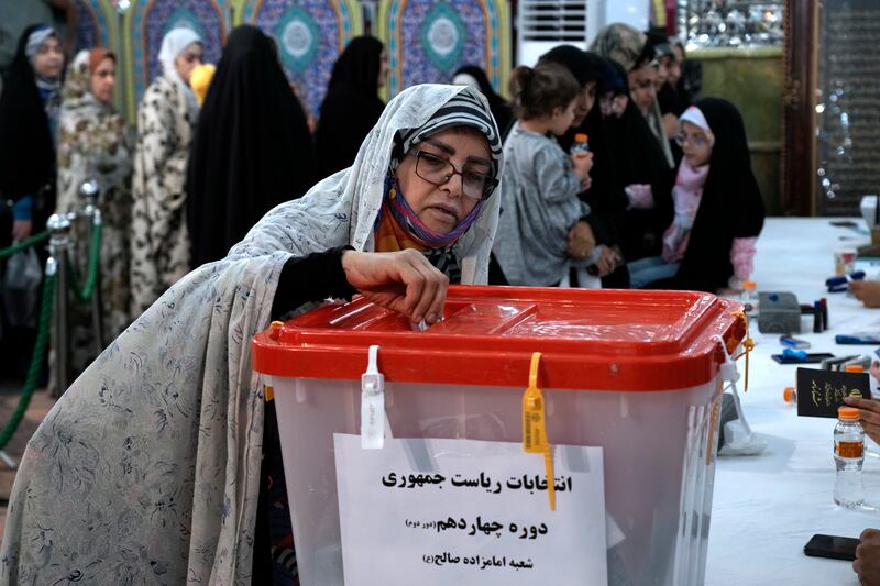 Iran held a run-off election that pitted a hard-line former nuclear negotiator against a reformist (AP)