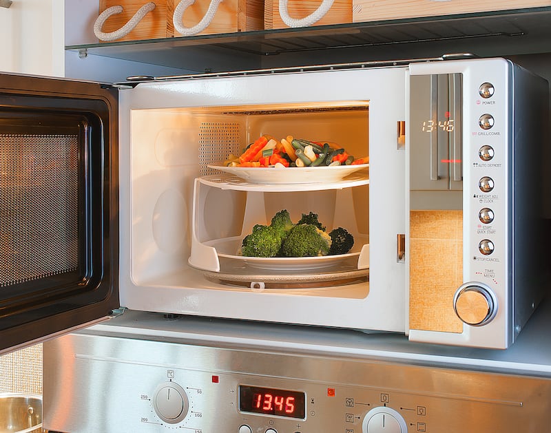 Two-tier microwave oven tray enables heating two plates at once