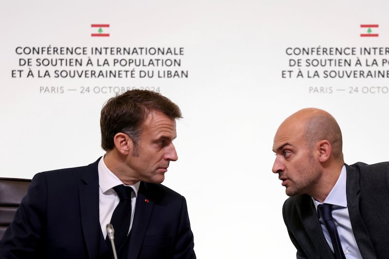 France’s President Emmanuel Macron talks with French foreign minister Jean-Noel Barrot during an international conference for Lebanon in Paris (Alain Jocard/AP)