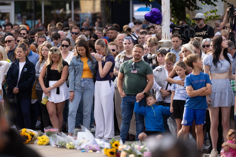 Members of the public take part in a vigil near to the scene of the attack in Hart Street, Southport