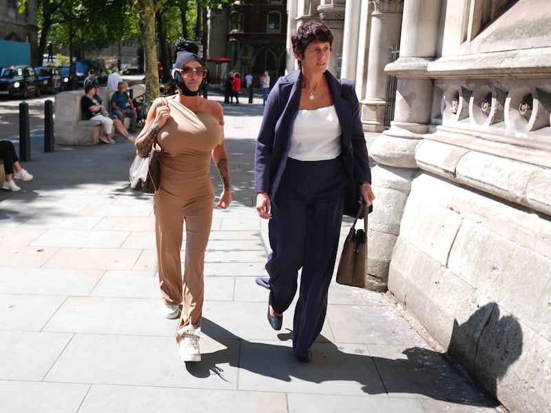 Ms Price wore a beige outfit and a black head covering on her arrival to the court