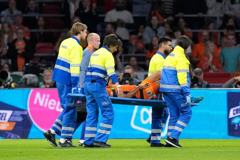 Nathan Ake of the Netherlands is taken off the pitch (Peter Dejong/AP)