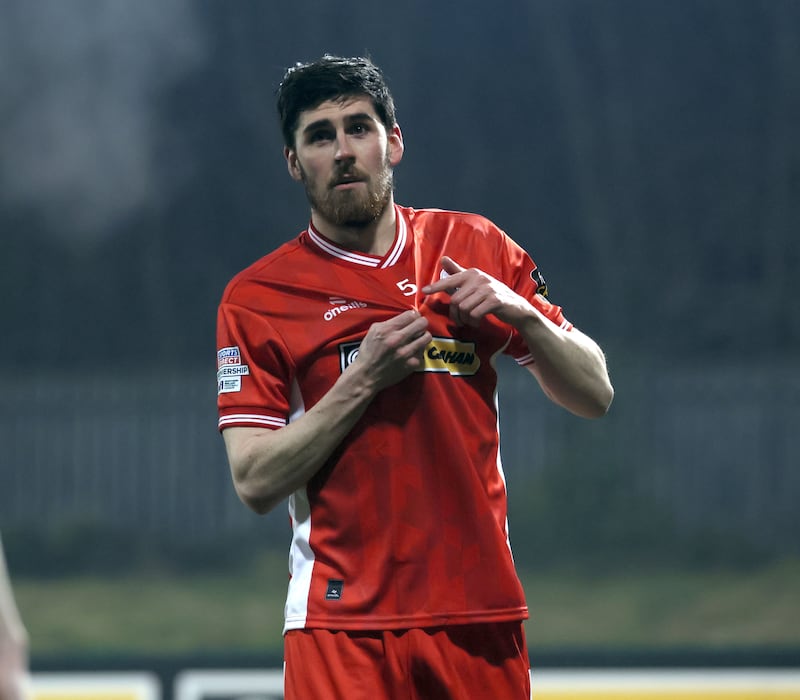 Cliftonville's Kris Lowe points to the number five on his jersey, to honour former team-mate Michael Newberry who died suddenly