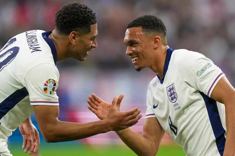 England’s Jude Bellingham, left, celebrates with Trent Alexander-Arnold after scoring during the win over Serbia (Martin Meissner/AP)