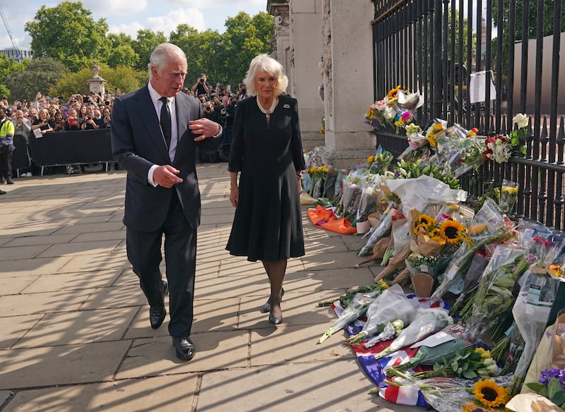 The King and Queen view floral tributes left outside Buckingham Palace the day after Queen Elizabeth II’s death