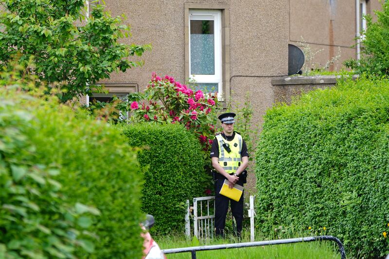 Police were seen standing guard at a property