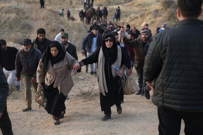 People walk towards the infamous Saydnaya military prison (Ghaith Alsayed/AP)