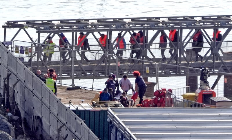 A group of people thought to be migrants are brought in to Dover from a Border Force vessel on October 18