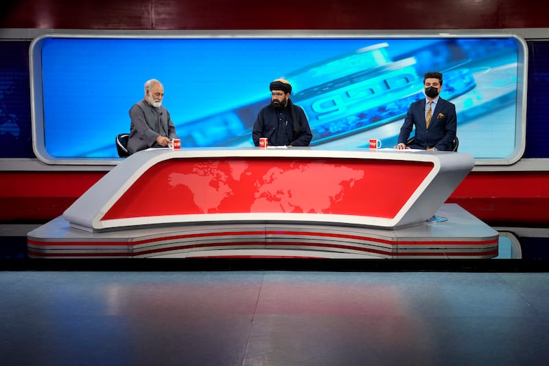 TV anchor Nesar Nabil wears a face mask to protest the Taliban’s new order that female presenters cover their faces, as he reads the news on TOLOnews (Ebrahim Noroozi/AP)