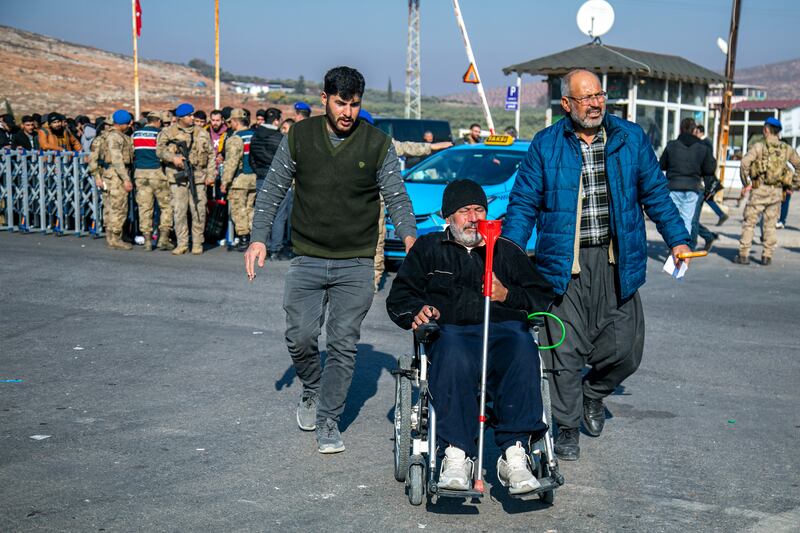 Syrians arrive to cross into Syria from Turkey at the Cilvegozu border gate, near the town of Antakya, southern Turkey (Metin Yoksu/AP)