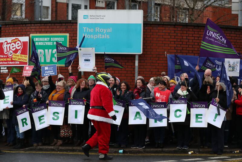 Man dressed as Santa delivers sweets to the picket line outside the Royal Victoria Hospital in Belfast as nurses take part in a 12-hour strike over pay. Picture by Liam McBurney/PA Wire&nbsp;