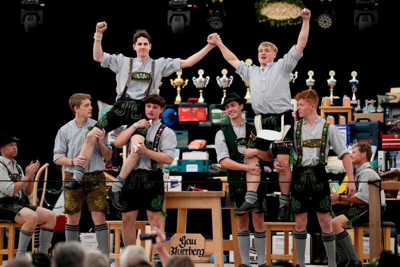 Competitors celebrate their success in the Fingerhakeln contest (Matthias Schrader/AP)