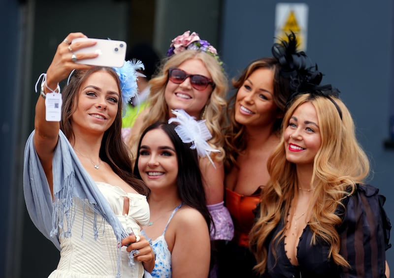 Racegoers take a selfie on day three of the 2024 Randox Grand National Festival at Aintree Racecourse, Liverpool