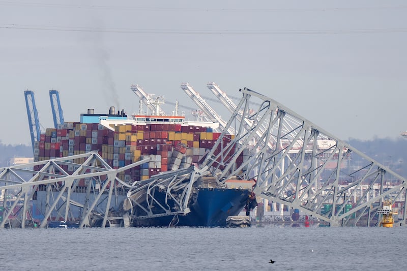 A container ship rests against the wreckage of the Francis Scott Key Bridge in Baltimore (Mark Schiefelbein/AP)