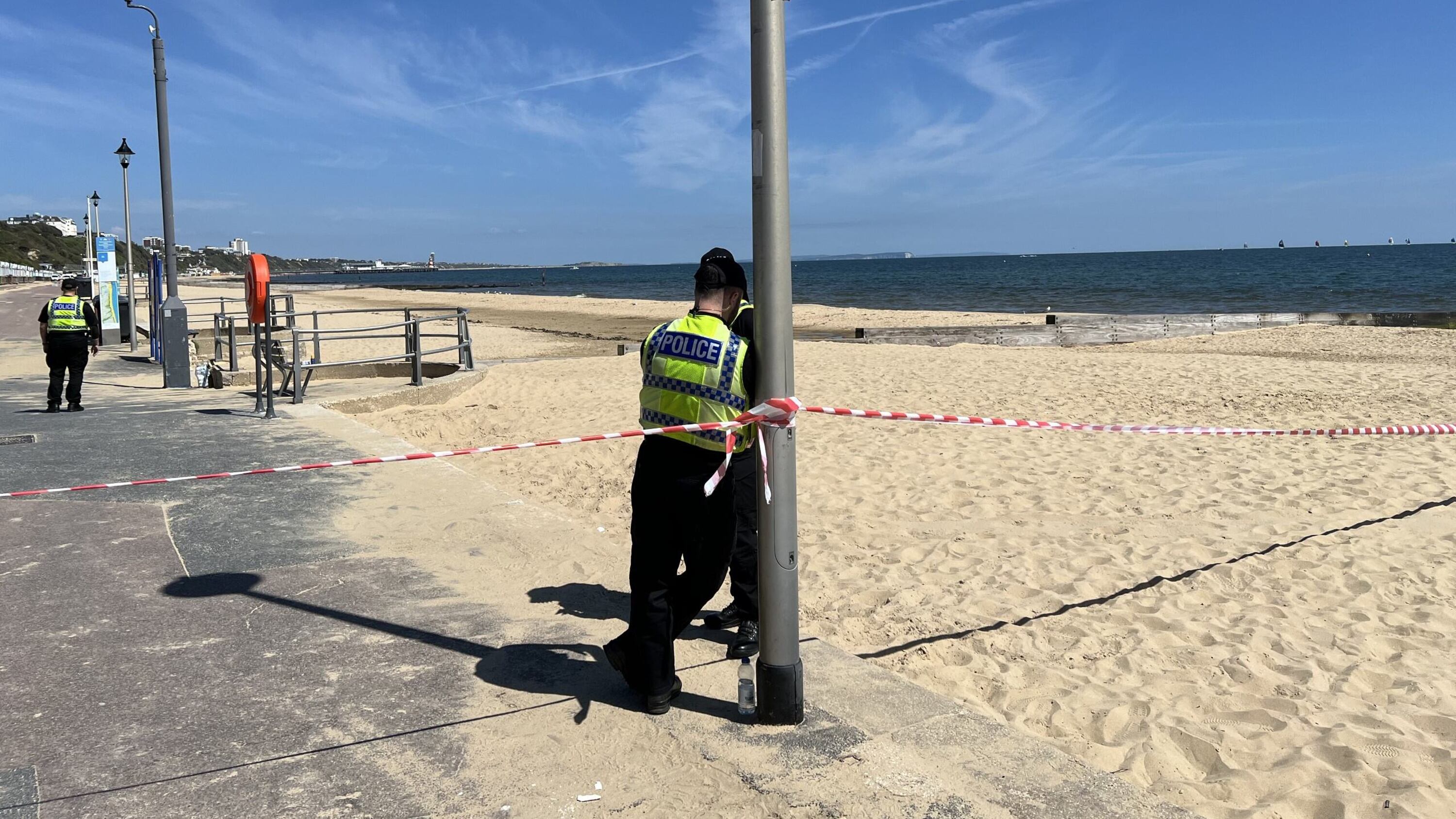 Police officers at the scene of the incident at Durley Chine Beach in Bournemouth