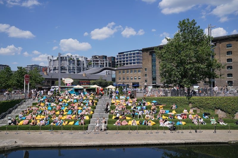 People enjoying the warm weather in Granary Square, London