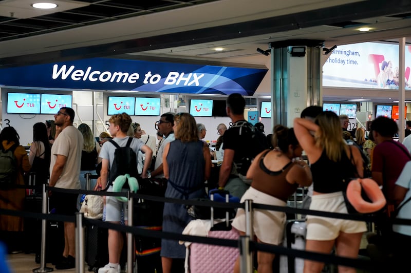 Passengers queue at Birmingham Airport during the IT outage