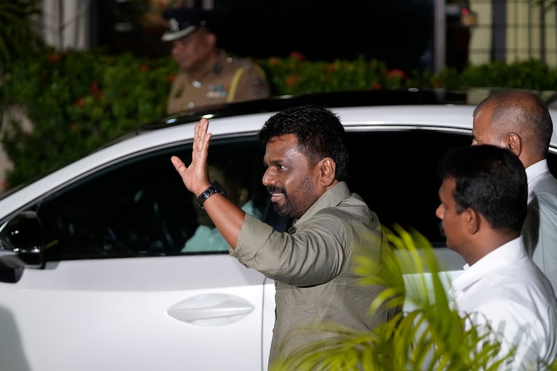 Anura Kumara Dissanayake waves as he arrives at the Election Commission office in Colombo, Sri Lanka, after winning the Sri Lankan presidential election (Eranga Jayawardane/AP)