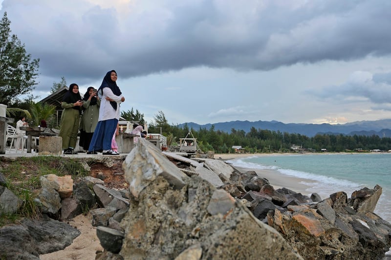 Young girls enjoy the view at Lampuuk beach, one of the areas hardest hit by the Indian Ocean tsunami in 2004 (Achmad Ibrahim/AP)