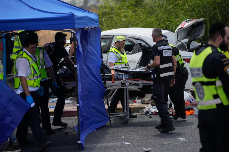 A car slammed into pedestrians waiting at a bus stop (Ohad Zwigenberg/AP)