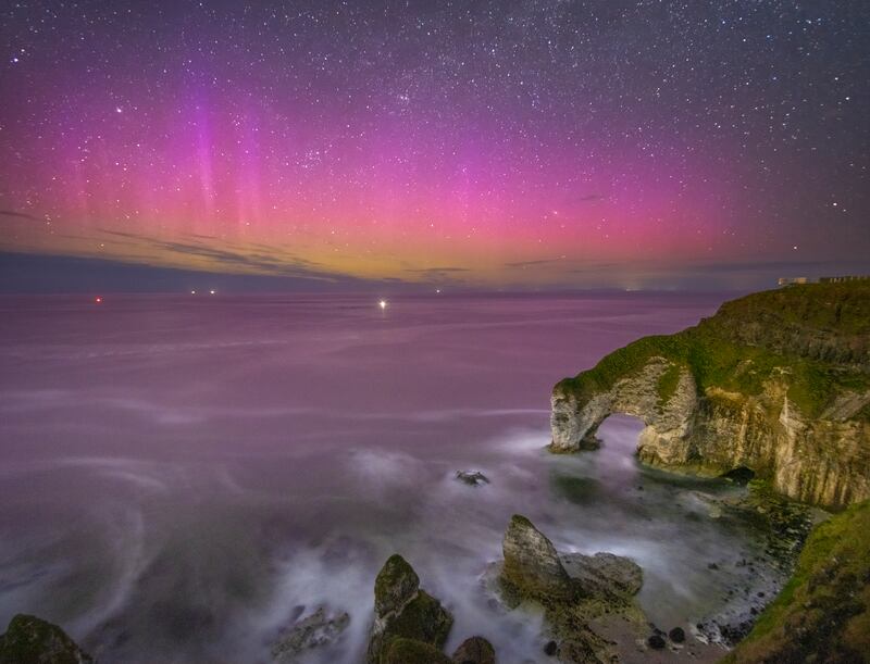 The northern lights captured on camera by Co Antrim photographer and geography teacher Alistair Hamill at The Wishing Arch, Bushmills