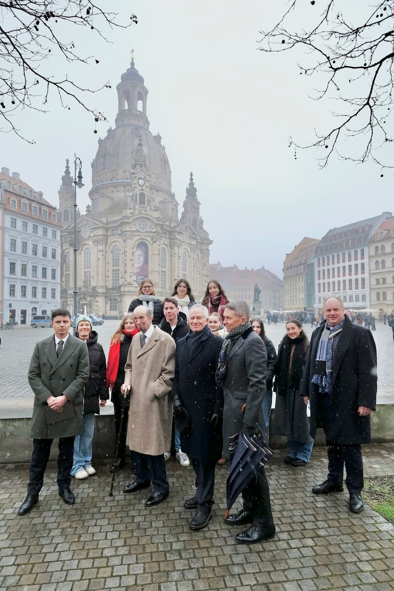 The duke poses for a photo in front of the restored church