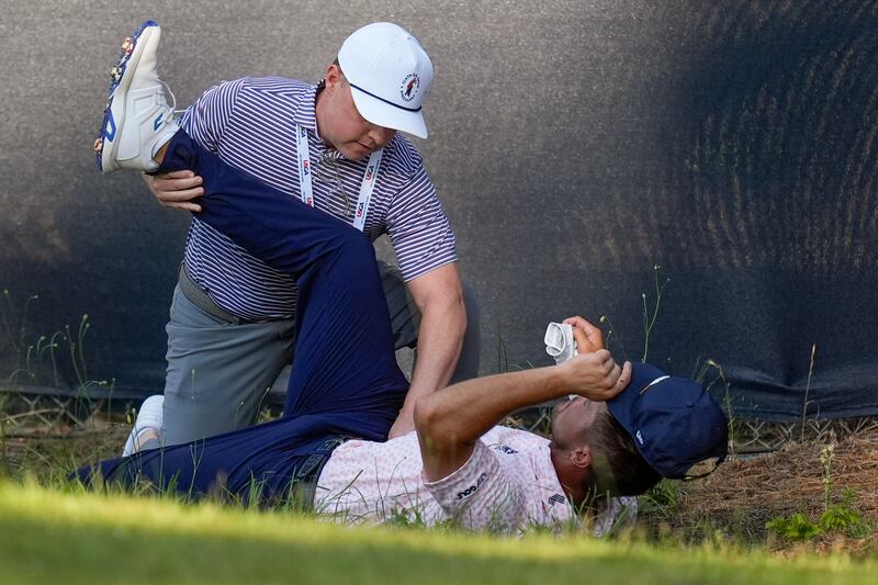 Bryson DeChambeau gets treatment on the 11th hole during the third round of the US Open (Mike Stewart/AP)