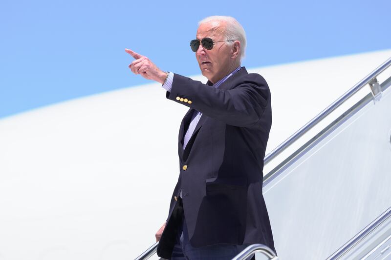 President Joe Biden points as he arrives on Air Force One at Dane County Regional Airport to attend a campaign rally in Madison, Wisconsin (Manuel Balce Ceneta/AP)