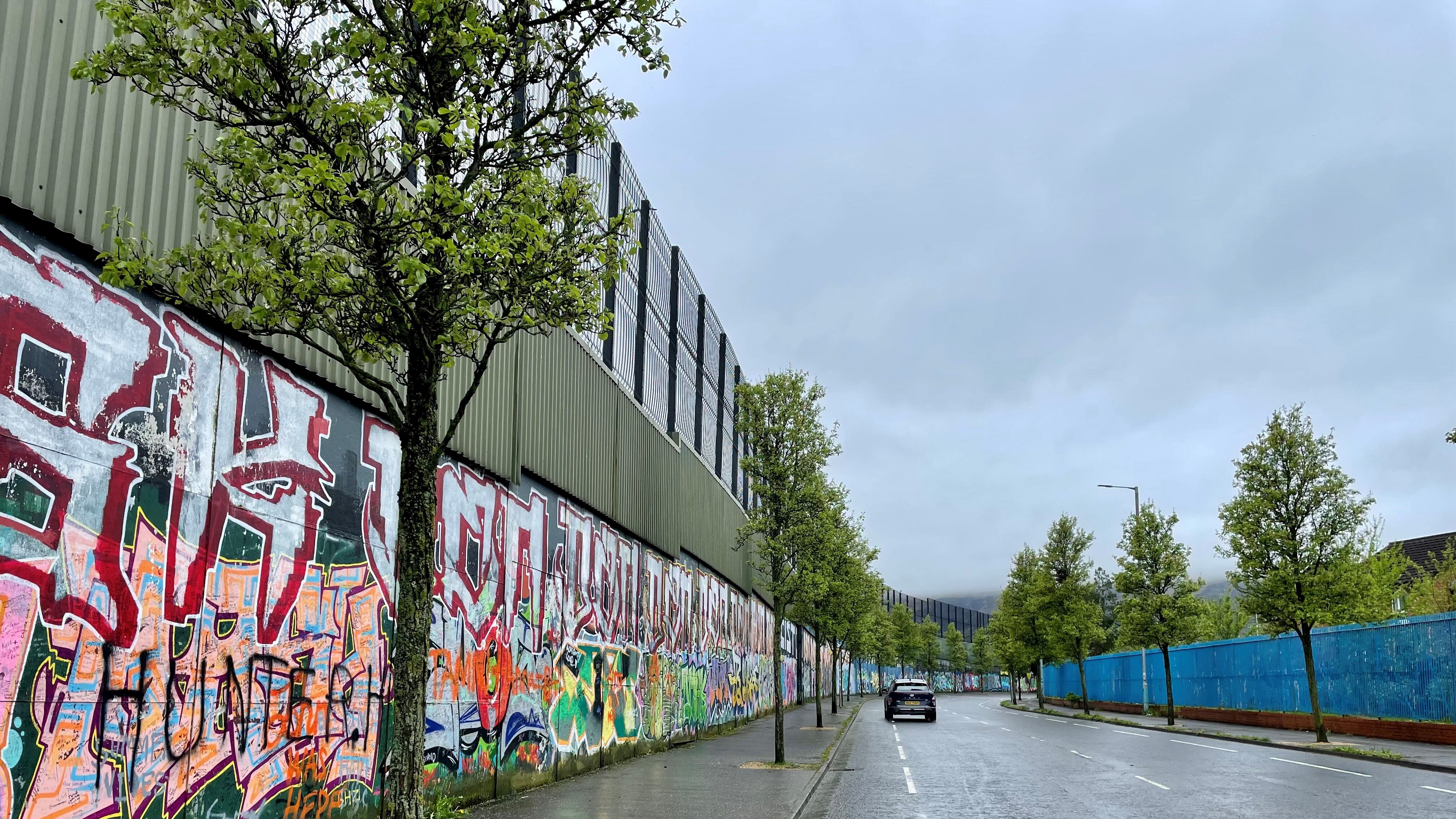 Peace wall on Cupar Way in Belfast .