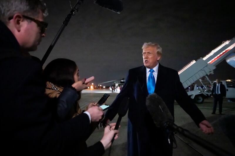 President Donald Trump speaks to reporters next to Air Force One (Ben Curtis/AP)