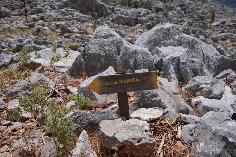 A direction sign on a rocky path in the hills of Pedi, a small fishing village in Symi, Greece, pointing towards Agia Marina, where the body of Michael Mosley was discovered