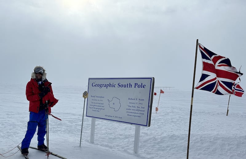 Harpreet Chandi, known as Polar Preet, beside the signpost at the end of her unsupported solo South Pole ski expedition