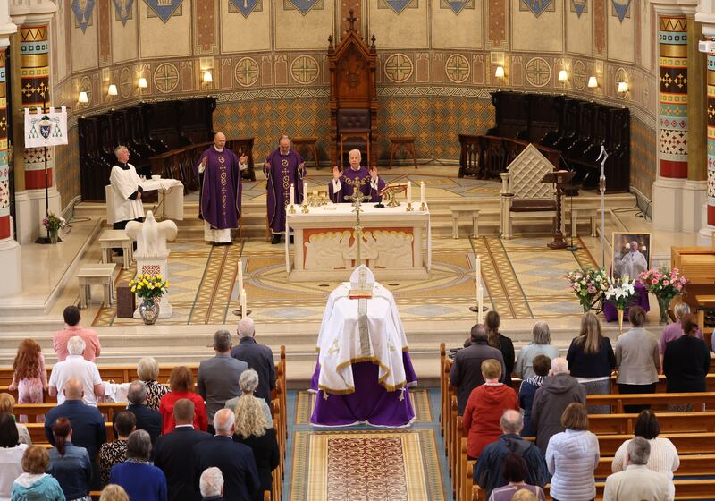 The remains of Archbishop Noel Treanor  at St Peter’s Cathedral on Monday for those who wish to pay their respects, ahead of the Funeral on Tuesday.
PICTURE COLM LENAGHAN