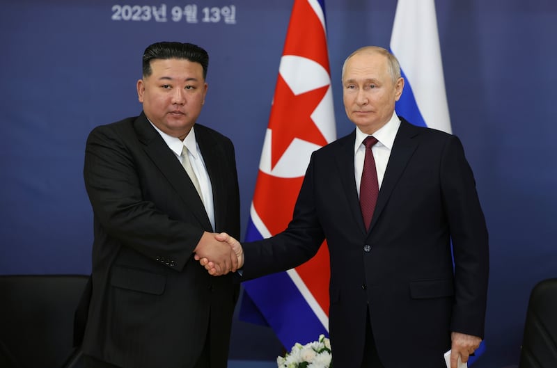 Russian President Vladimir Putin, right, and North Korean leader Kim Jong Un shake hands during their meeting at the Vostochny cosmodrome (Vladimir Smirnov/AP)