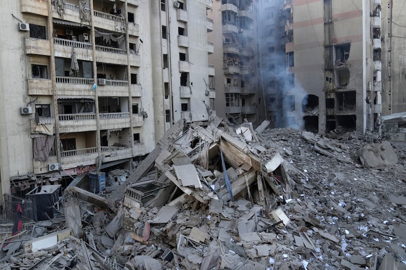 Smoke rises from a destroyed building hit by an Israeli airstrike on Dahiyeh (Hussein Malla/AP)