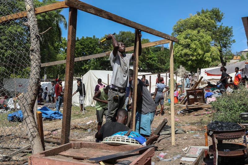 Residents of the Nazon neighbourhood displaced by gang violence construct a tent encampment in Port-au-Prince, Haiti (Odelyn Joseph/AP)