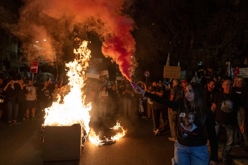 Israelis protest against Prime Minister Benjamin Netanyahu near his residence in Jerusalem, a day after he dismissed his defence minister Yoav Gallant (Ohad Zwigenberg/AP)