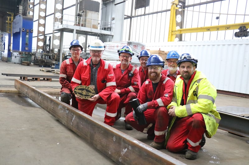 Brian Welsh, H&W Operations Manager with his team of apprentices (with the DCDR's David Crone, underframe designer, at the back) with the marked out steel for the new underframe.