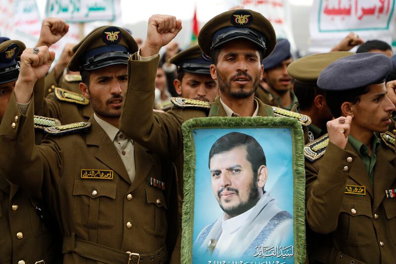 Supporters hold a photo of the Houthi leader Abdul-Malik Badruldeen al-Houthi (Osamah Abdulrahman/AP)