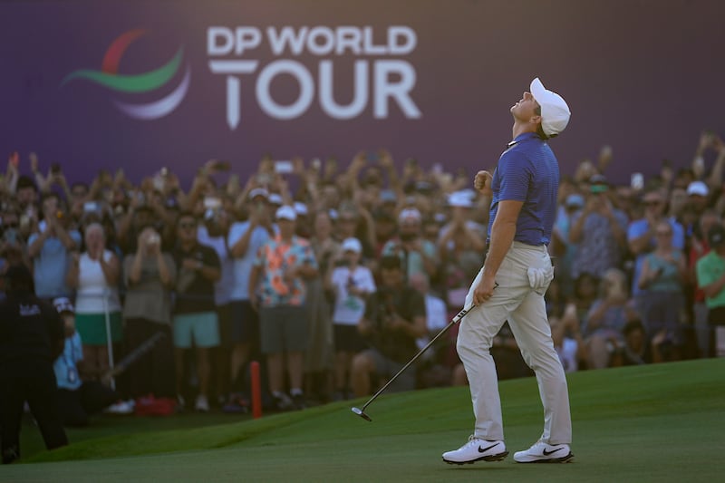 McIlroy celebrated after his winning putt in Dubai (Altaf Qadri/AP)