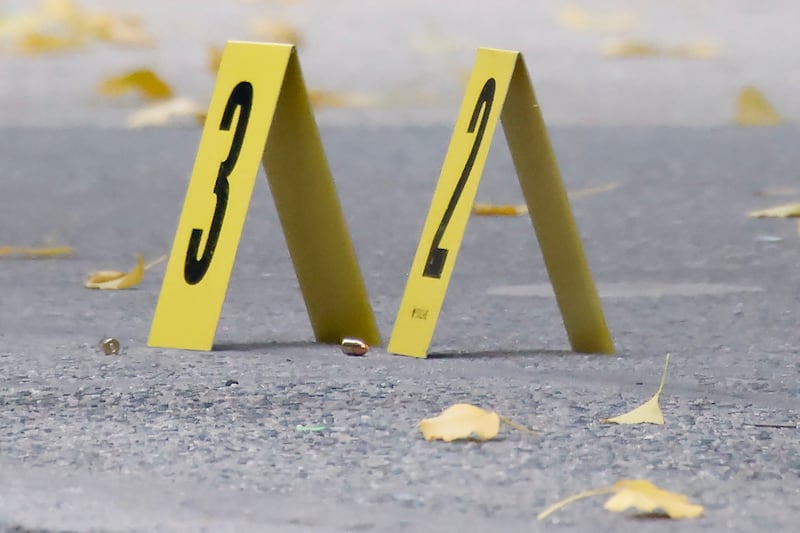 Bullets lie on the pavement at the scene outside the Hilton Hotel (Stefan Jeremiah/AP)