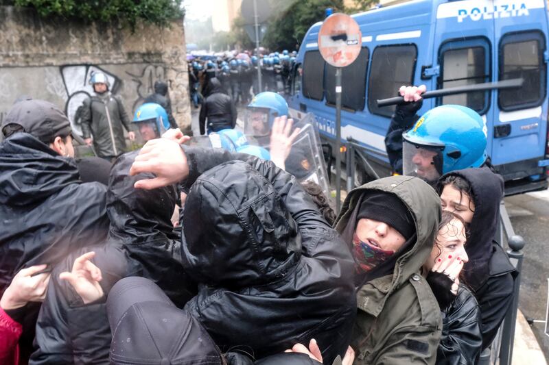 Protesters clash with riot police (LaPresse via AP)