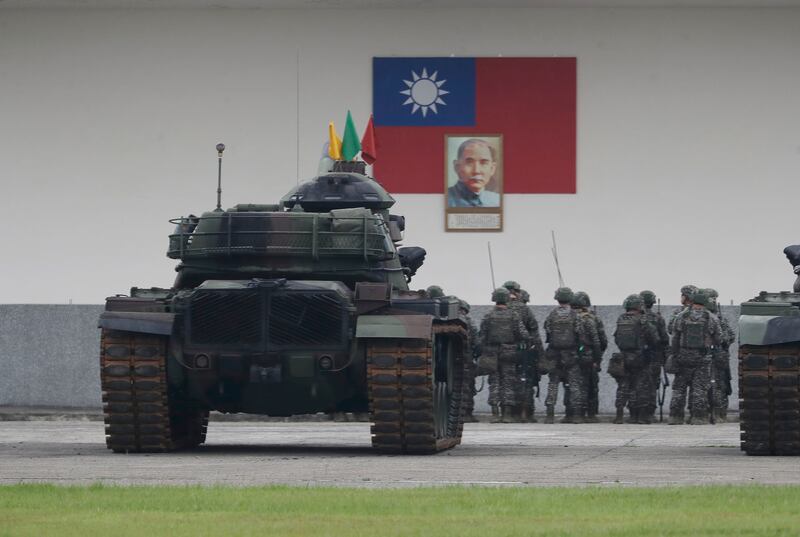 Soldiers are assembled in front of the Taiwan national flag in Taoyuan, Northern Taiwan (AP)