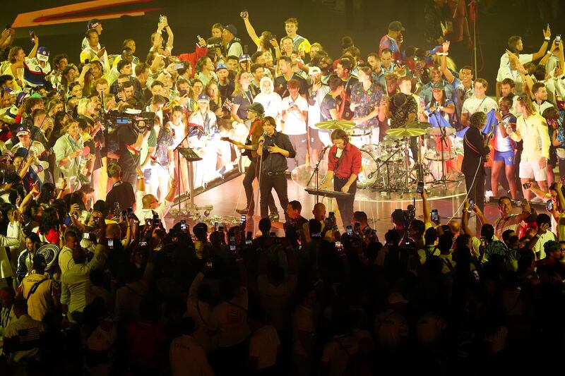 Athletes invade the stage as Phoenix perform during the closing ceremony